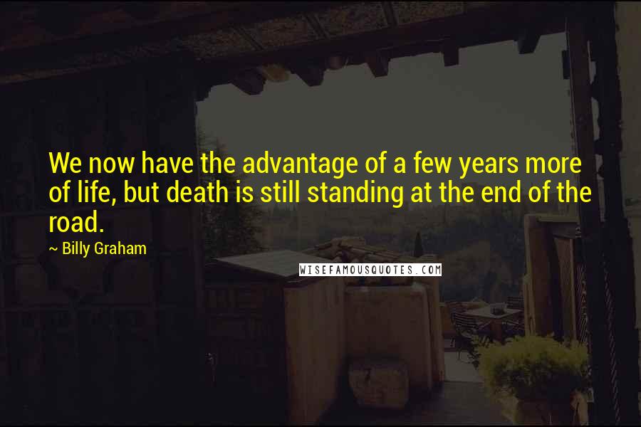 Billy Graham Quotes: We now have the advantage of a few years more of life, but death is still standing at the end of the road.