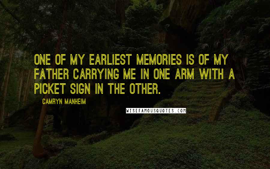 Camryn Manheim Quotes: One of my earliest memories is of my father carrying me in one arm with a picket sign in the other.