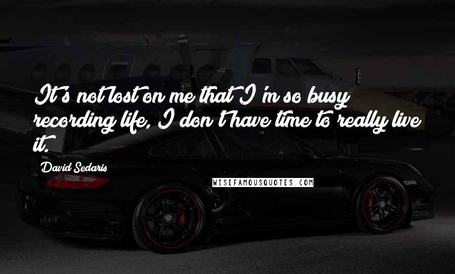 David Sedaris Quotes: It's not lost on me that I'm so busy recording life, I don't have time to really live it.