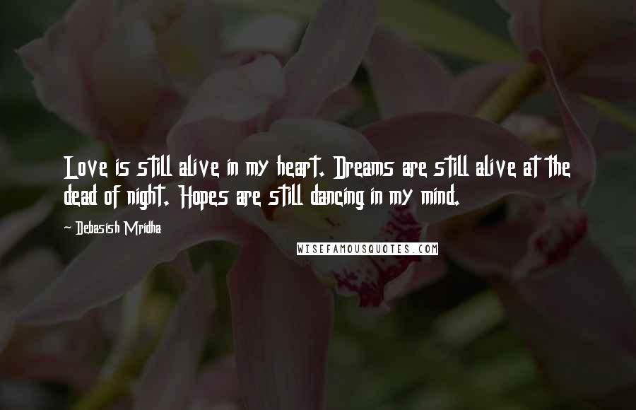 Debasish Mridha Quotes: Love is still alive in my heart. Dreams are still alive at the dead of night. Hopes are still dancing in my mind.