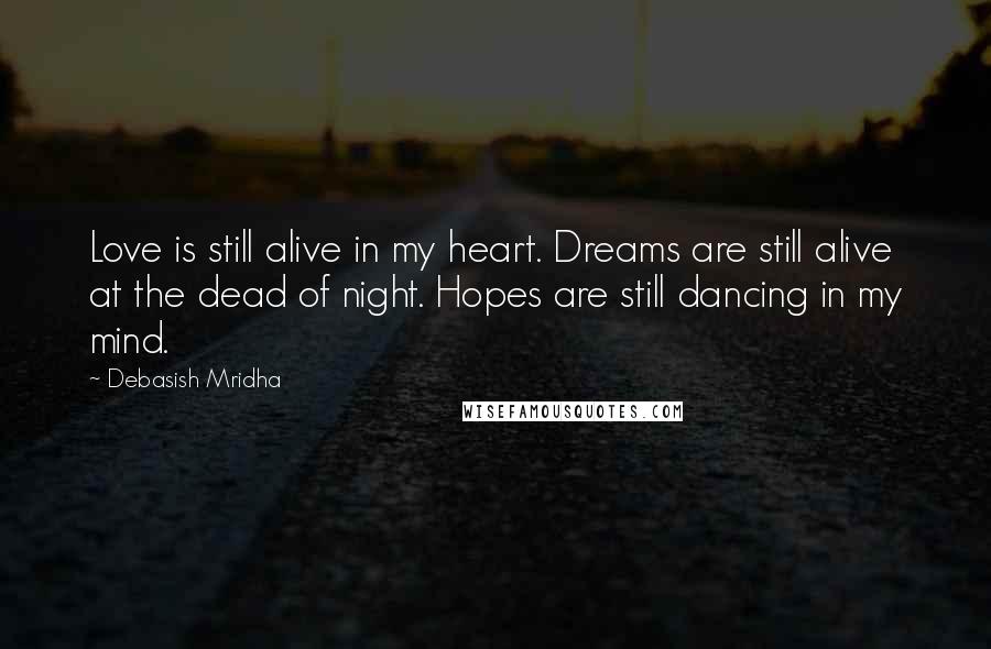 Debasish Mridha Quotes: Love is still alive in my heart. Dreams are still alive at the dead of night. Hopes are still dancing in my mind.
