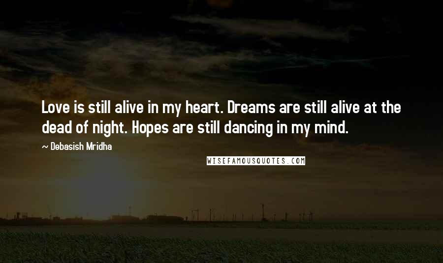 Debasish Mridha Quotes: Love is still alive in my heart. Dreams are still alive at the dead of night. Hopes are still dancing in my mind.