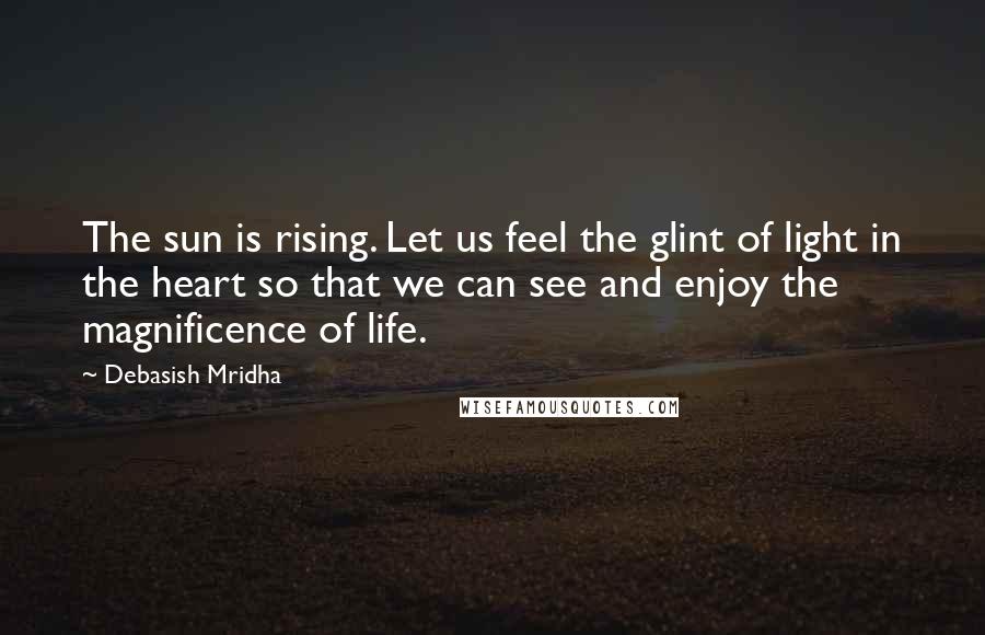 Debasish Mridha Quotes: The sun is rising. Let us feel the glint of light in the heart so that we can see and enjoy the magnificence of life.