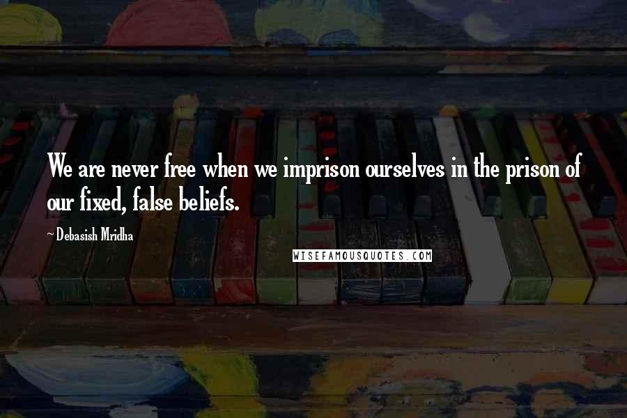 Debasish Mridha Quotes: We are never free when we imprison ourselves in the prison of our fixed, false beliefs.