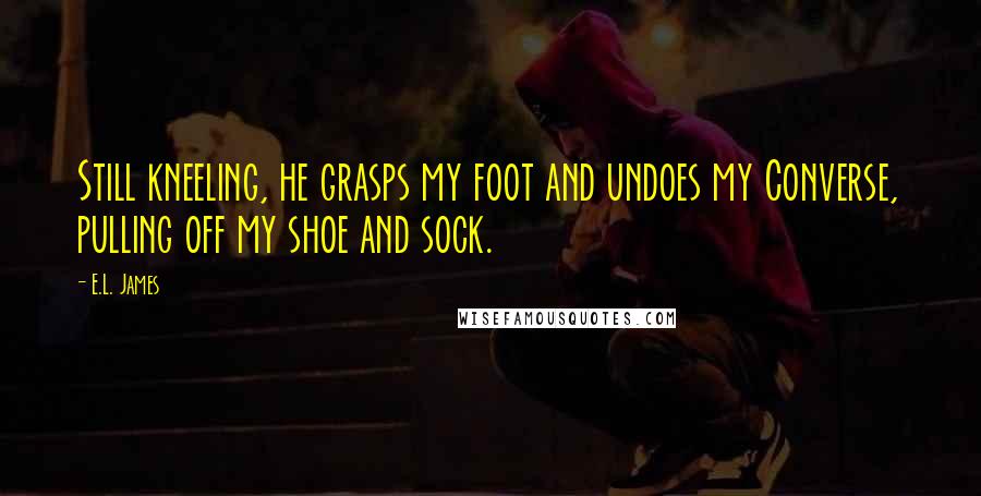 E.L. James Quotes: Still kneeling, he grasps my foot and undoes my Converse, pulling off my shoe and sock.