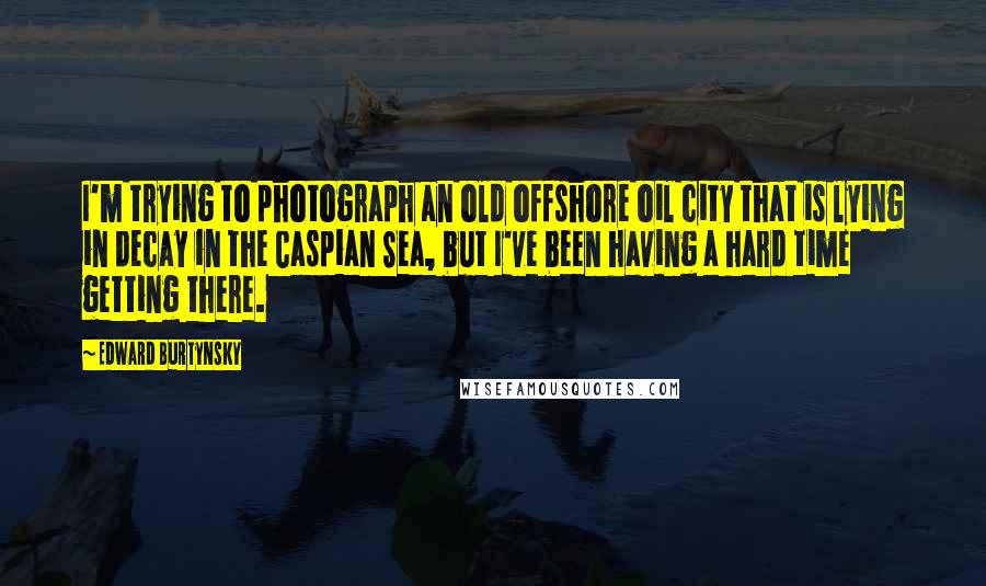 Edward Burtynsky Quotes: I'm trying to photograph an old offshore oil city that is lying in decay in the Caspian Sea, but I've been having a hard time getting there.