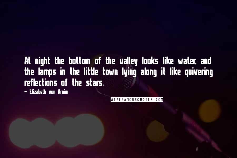 Elizabeth Von Arnim Quotes: At night the bottom of the valley looks like water, and the lamps in the little town lying along it like quivering reflections of the stars.