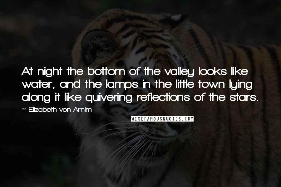 Elizabeth Von Arnim Quotes: At night the bottom of the valley looks like water, and the lamps in the little town lying along it like quivering reflections of the stars.