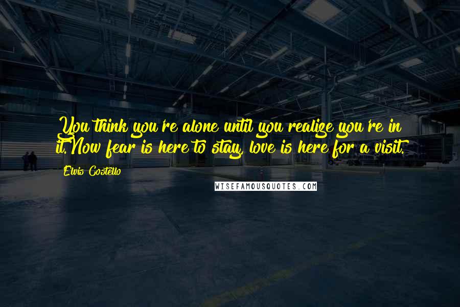 Elvis Costello Quotes: You think you're alone until you realize you're in it.Now fear is here to stay, love is here for a visit.