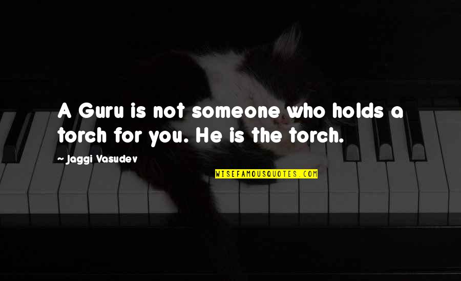 A Guru Quotes By Jaggi Vasudev: A Guru is not someone who holds a
