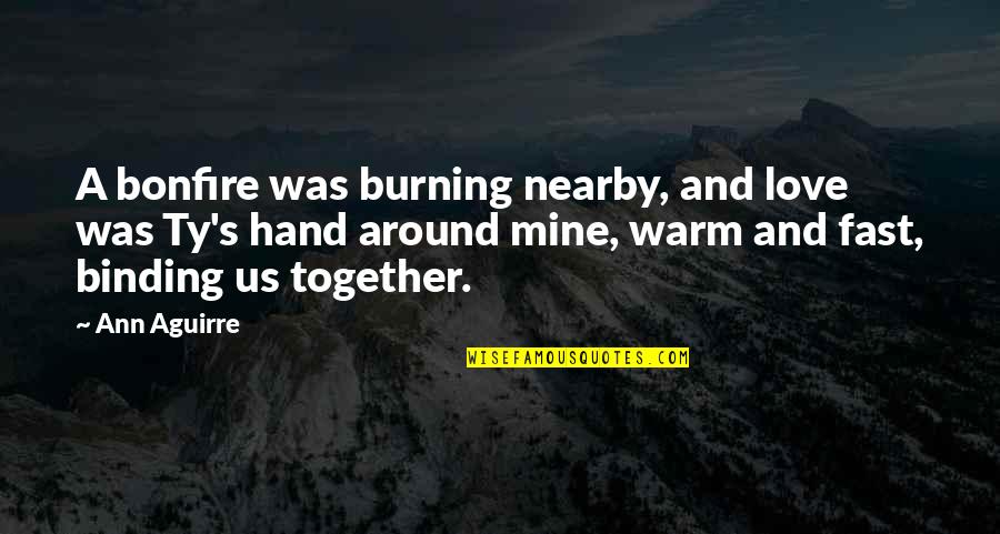 A Hand Quotes By Ann Aguirre: A bonfire was burning nearby, and love was