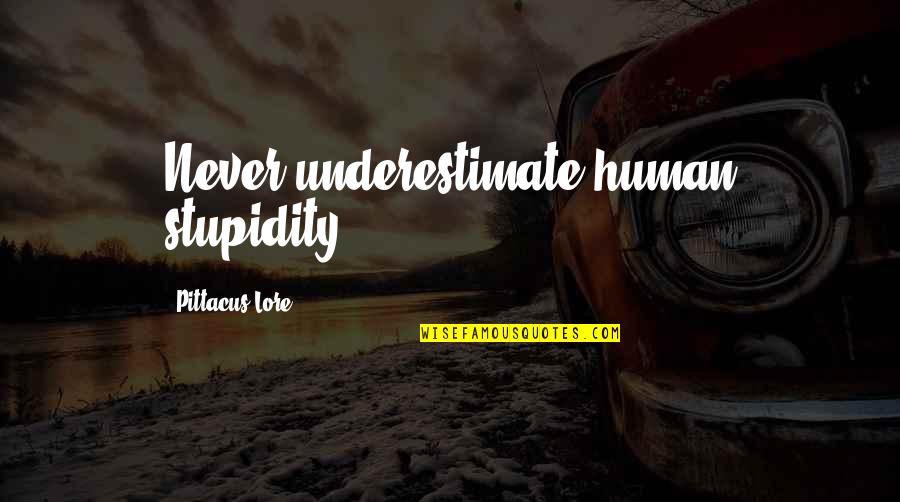 Bagnati Dal Sole Quotes By Pittacus Lore: Never underestimate human stupidity. Bagnati Dal Sole Quotes By Pittacus Lore: Never underestimate human stupidity.
