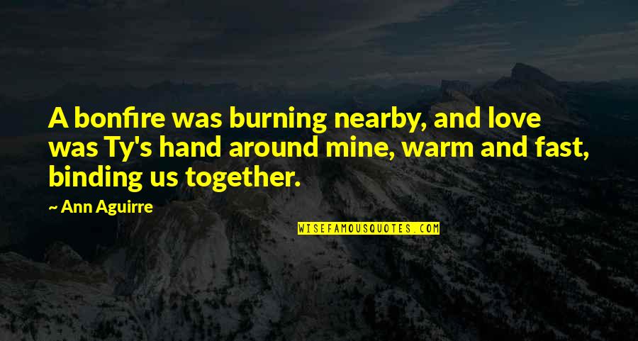 Binding Love Quotes By Ann Aguirre: A bonfire was burning nearby, and love was