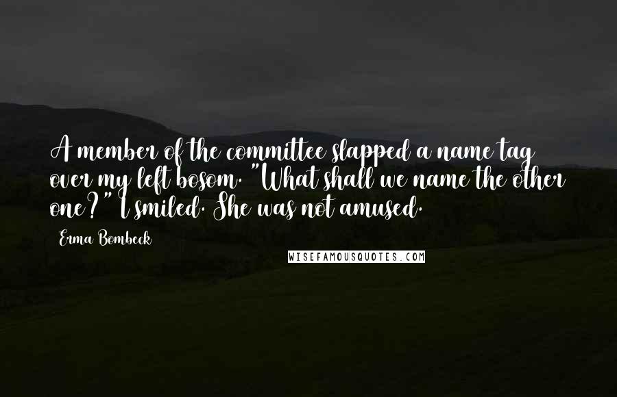 Erma Bombeck quotes: A member of the committee slapped a name tag over my left bosom. "What shall we name the other one?" I smiled. She was not amused.