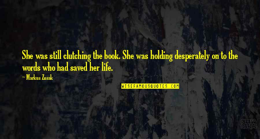 Holding Your Words Quotes By Markus Zusak: She was still clutching the book. She was