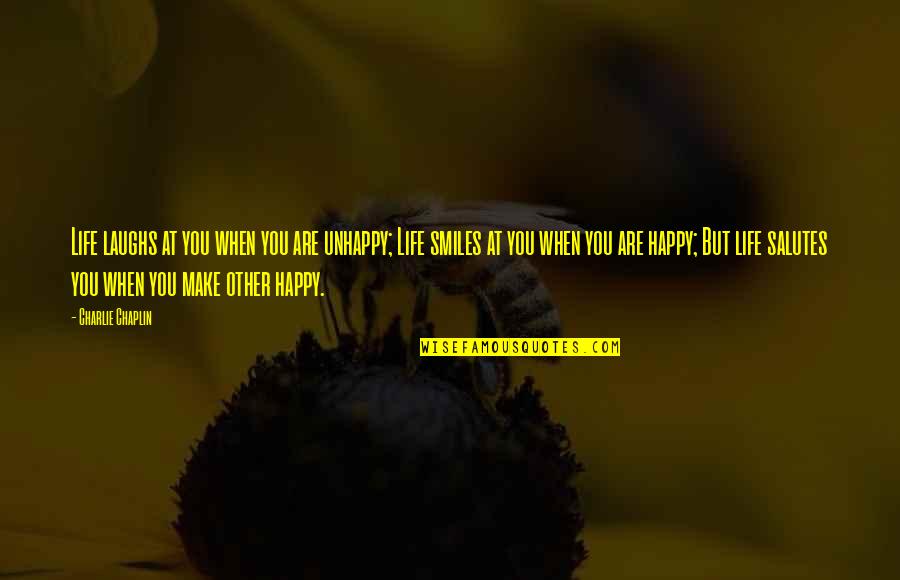 Laughs Quotes By Charlie Chaplin: Life laughs at you when you are unhappy;