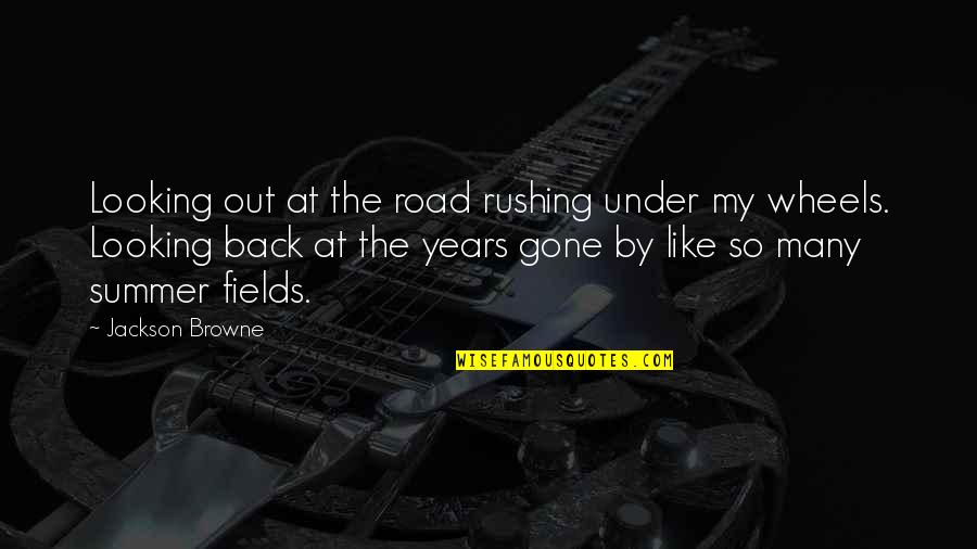 Rushing Quotes By Jackson Browne: Looking out at the road rushing under my