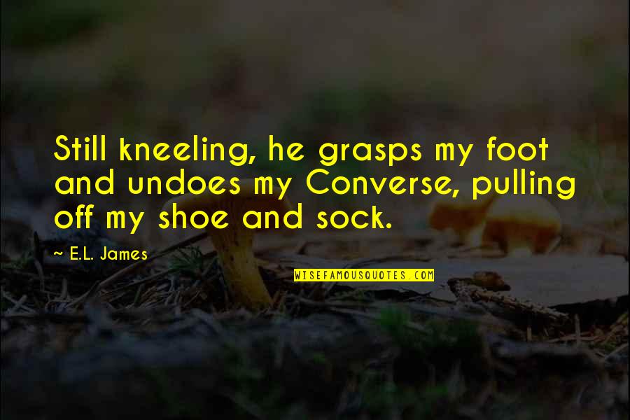 Single Status And Quotes By E.L. James: Still kneeling, he grasps my foot and undoes