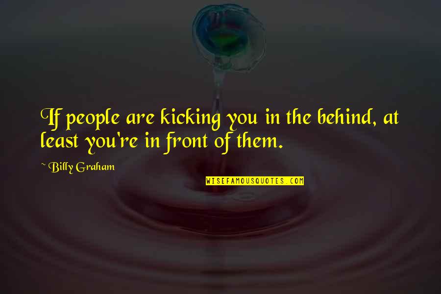 Smile Reaching Eyes Quotes By Billy Graham: If people are kicking you in the behind,