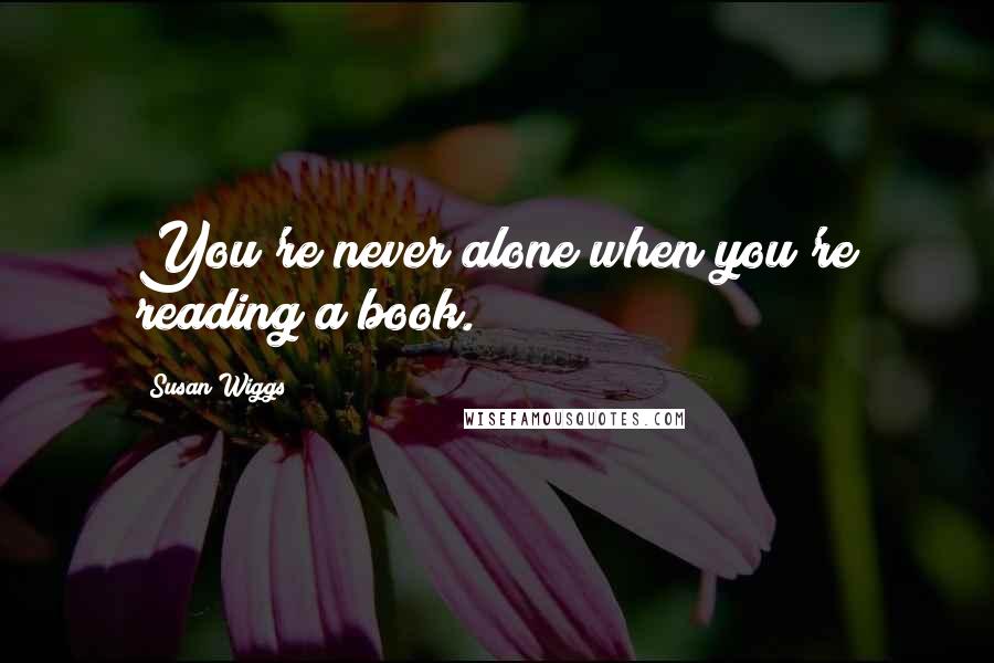 Susan Wiggs quotes: You're never alone when you're reading a book.