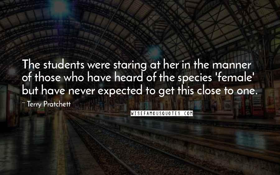 Terry Pratchett quotes: The students were staring at her in the manner of those who have heard of the species 'female' but have never expected to get this close to one.