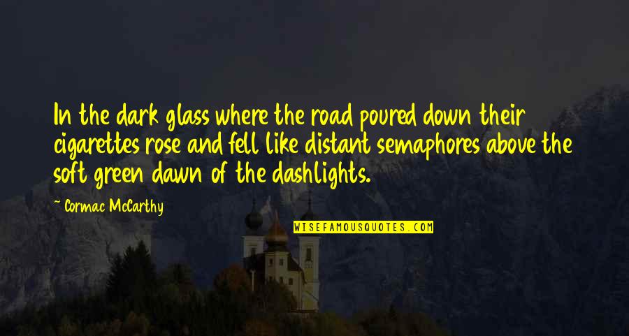 The Road Cormac Quotes By Cormac McCarthy: In the dark glass where the road poured