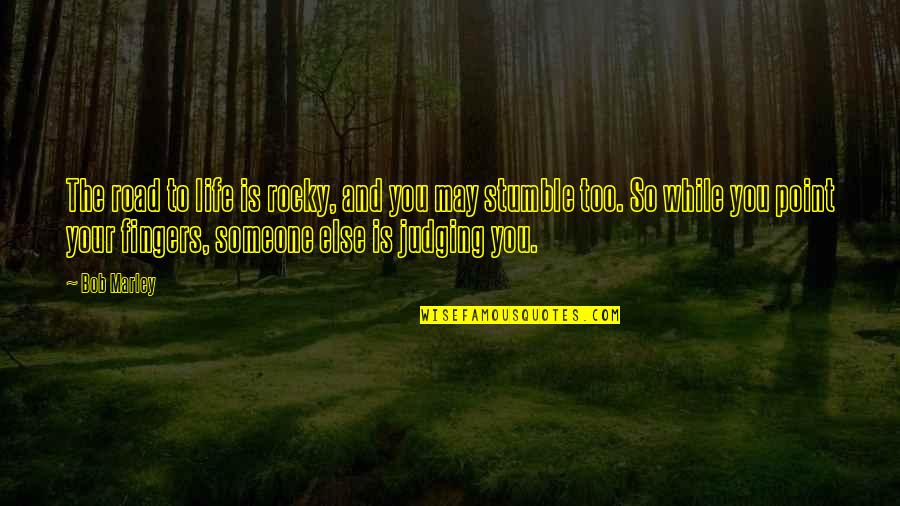 We All Stumble Quotes By Bob Marley: The road to life is rocky, and you