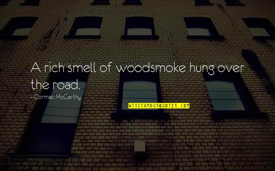 Woodsmoke Quotes By Cormac McCarthy: A rich smell of woodsmoke hung over the