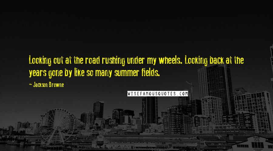 Jackson Browne Quotes: Looking out at the road rushing under my wheels. Looking back at the years gone by like so many summer fields.