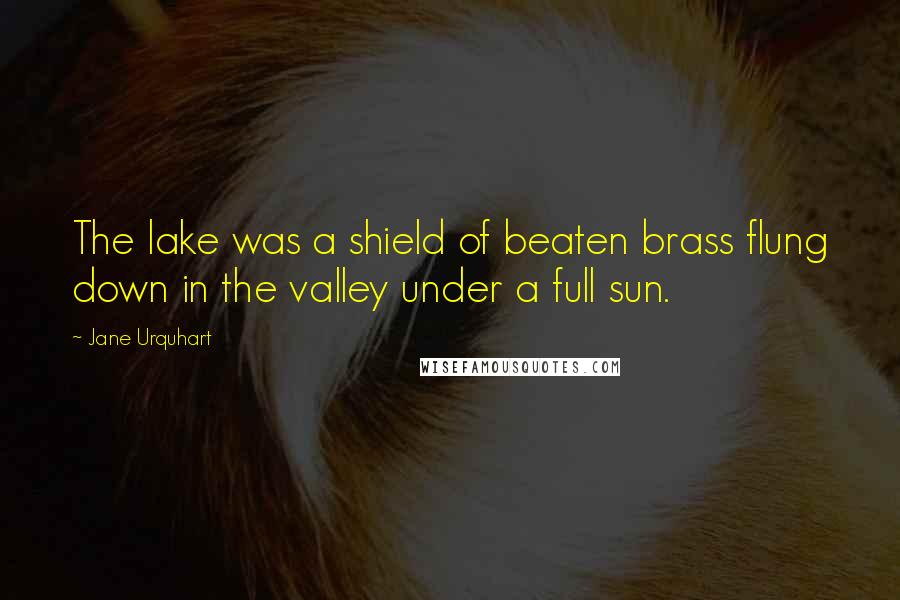 Jane Urquhart Quotes: The lake was a shield of beaten brass flung down in the valley under a full sun.