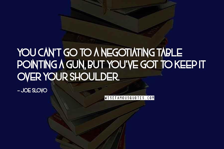 Joe Slovo Quotes: You can't go to a negotiating table pointing a gun, but you've got to keep it over your shoulder.