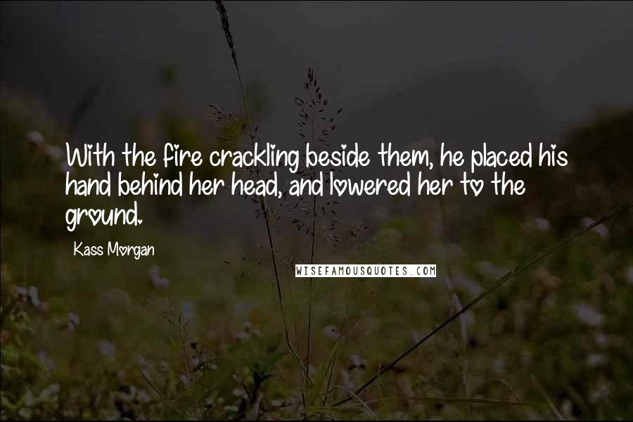 Kass Morgan Quotes: With the fire crackling beside them, he placed his hand behind her head, and lowered her to the ground.