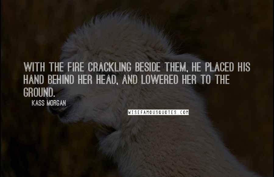 Kass Morgan Quotes: With the fire crackling beside them, he placed his hand behind her head, and lowered her to the ground.