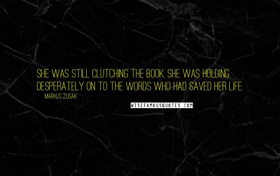 Markus Zusak Quotes: She was still clutching the book. She was holding desperately on to the words who had saved her life.