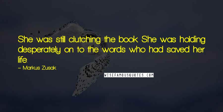 Markus Zusak Quotes: She was still clutching the book. She was holding desperately on to the words who had saved her life.