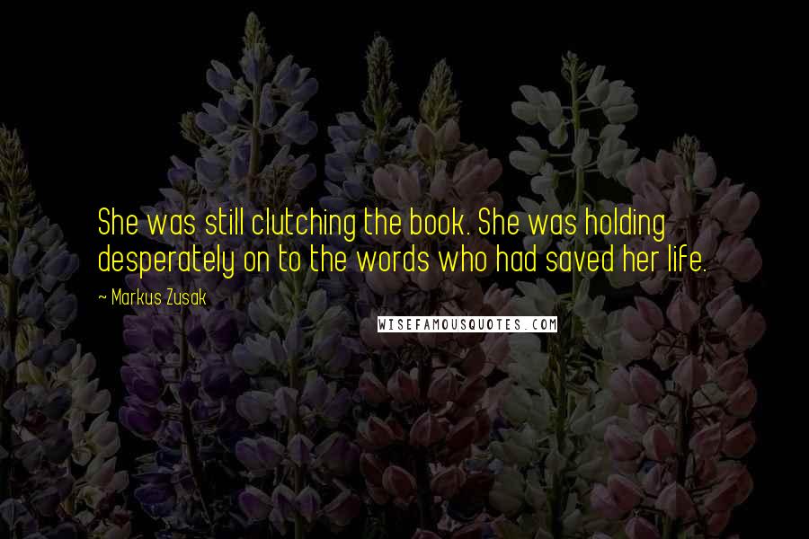 Markus Zusak Quotes: She was still clutching the book. She was holding desperately on to the words who had saved her life.