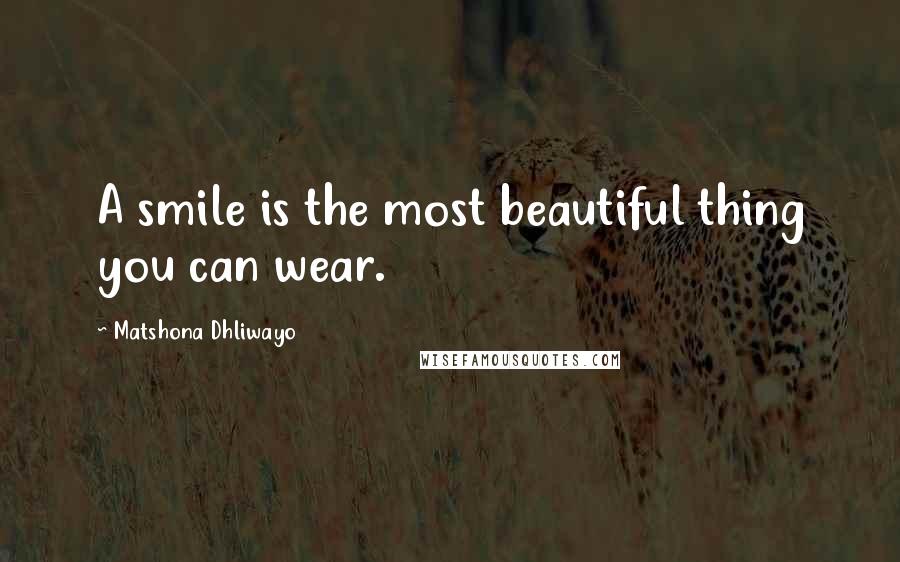 Matshona Dhliwayo Quotes: A smile is the most beautiful thing you can wear.