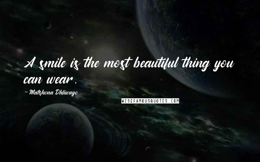 Matshona Dhliwayo Quotes: A smile is the most beautiful thing you can wear.