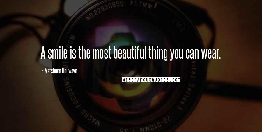 Matshona Dhliwayo Quotes: A smile is the most beautiful thing you can wear.