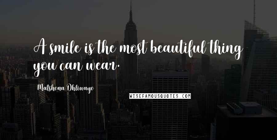 Matshona Dhliwayo Quotes: A smile is the most beautiful thing you can wear.