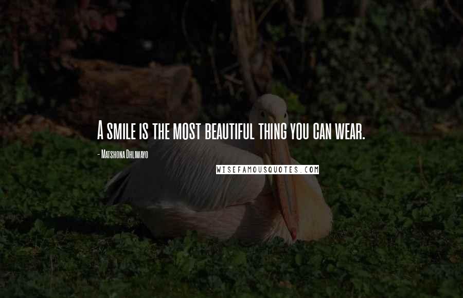 Matshona Dhliwayo Quotes: A smile is the most beautiful thing you can wear.