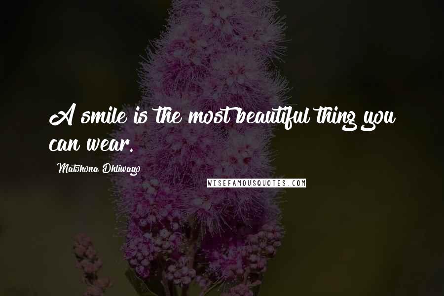 Matshona Dhliwayo Quotes: A smile is the most beautiful thing you can wear.