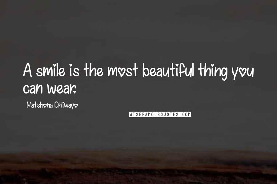 Matshona Dhliwayo Quotes: A smile is the most beautiful thing you can wear.