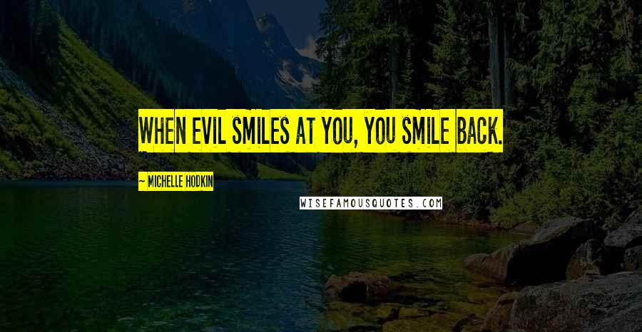 Michelle Hodkin Quotes: When evil smiles at you, you smile back.