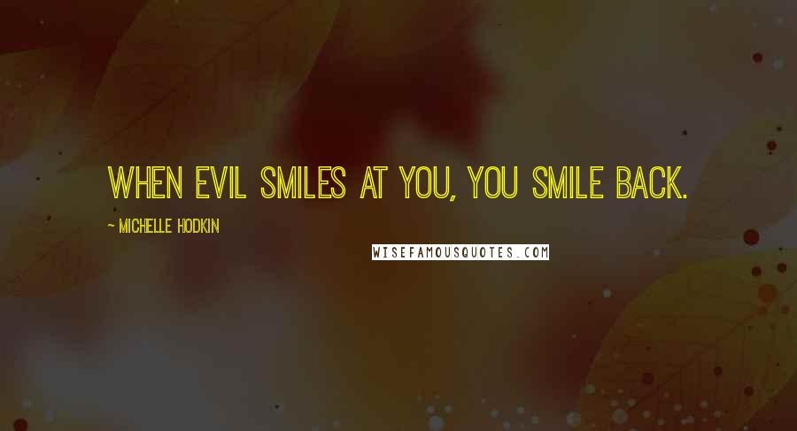 Michelle Hodkin Quotes: When evil smiles at you, you smile back.