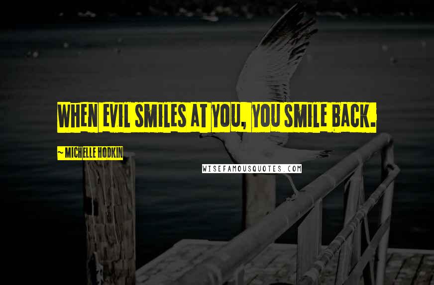 Michelle Hodkin Quotes: When evil smiles at you, you smile back.
