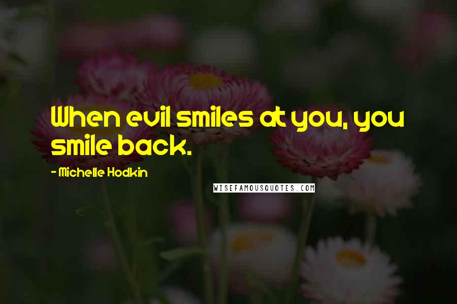 Michelle Hodkin Quotes: When evil smiles at you, you smile back.