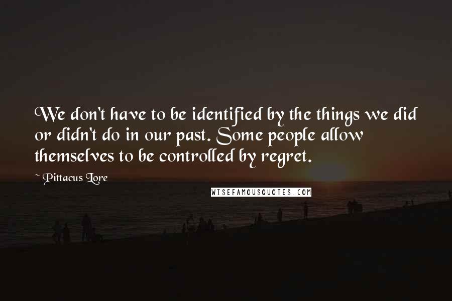 Pittacus Lore Quotes: We don't have to be identified by the things we did or didn't do in our past. Some people allow themselves to be controlled by regret.