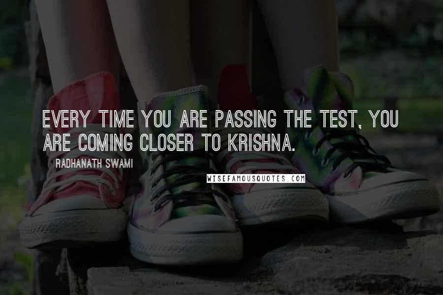 Radhanath Swami Quotes: Every time you are passing the test, you are coming closer to Krishna.