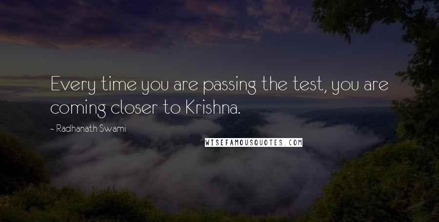 Radhanath Swami Quotes: Every time you are passing the test, you are coming closer to Krishna.